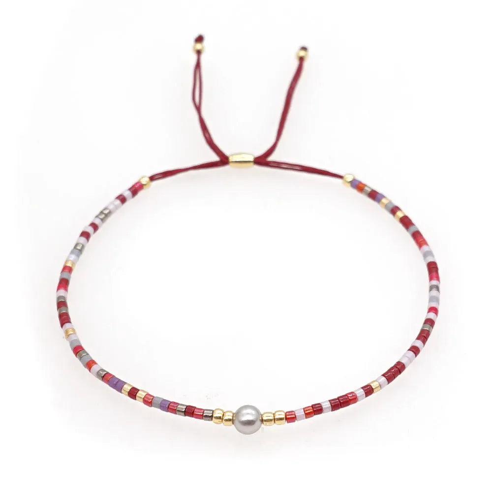 Women's handmade geometric beaded bracelet in bohemian style with glass and coloured glaze materials