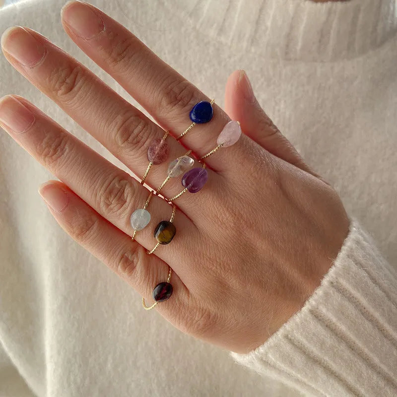 Geometric shaped agate ring for women in a solid colour on a neutral background.