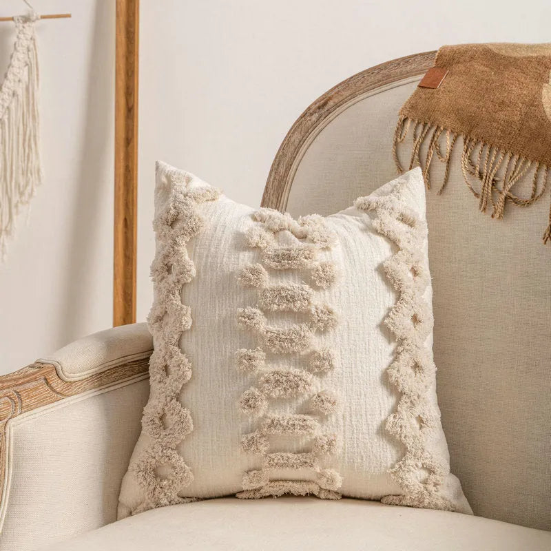 Knitted sofa pillow cover with tassel detailing in spiral dot pattern