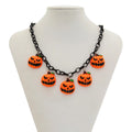 Halloween necklace with a colourful acrylic ghost and pumpkin cartoon pendant on a chain.
