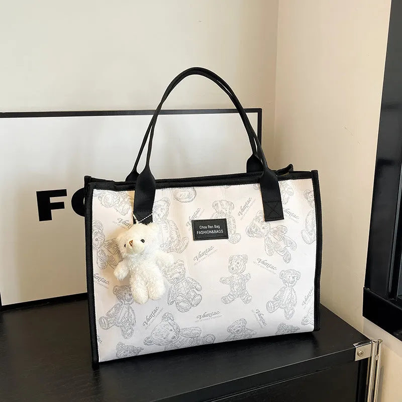 Women's black canvas tote bag with rhombus pattern, horizontal shape and shoulder strap