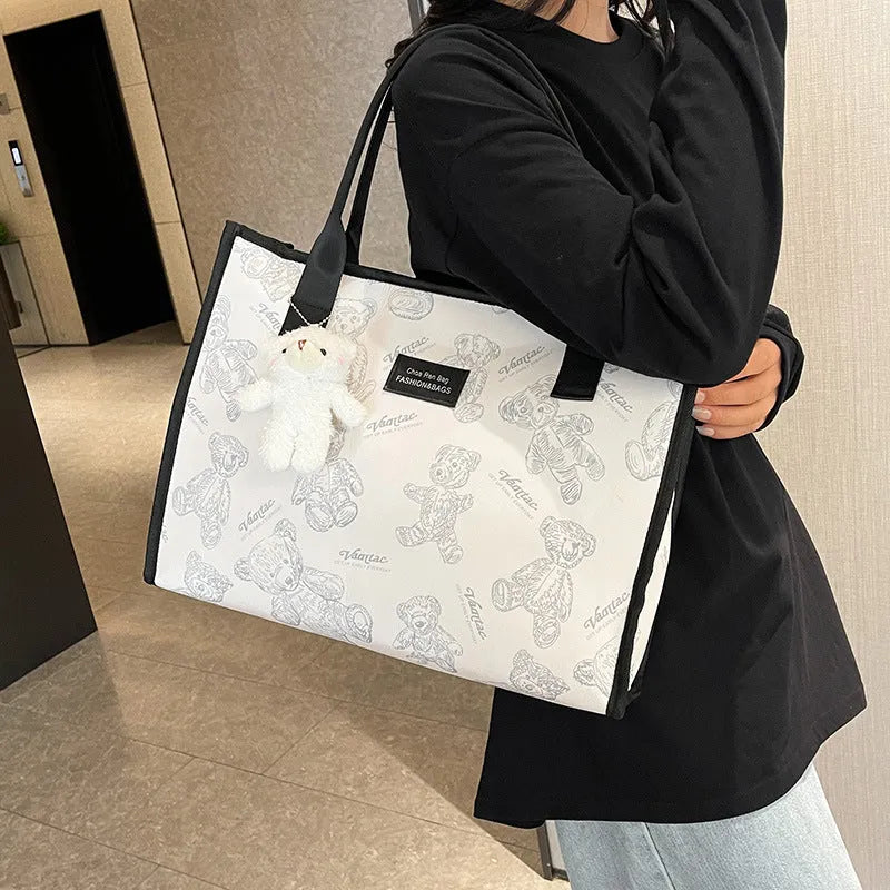 Women's black canvas tote bag with rhombus pattern, horizontal shape and shoulder strap
