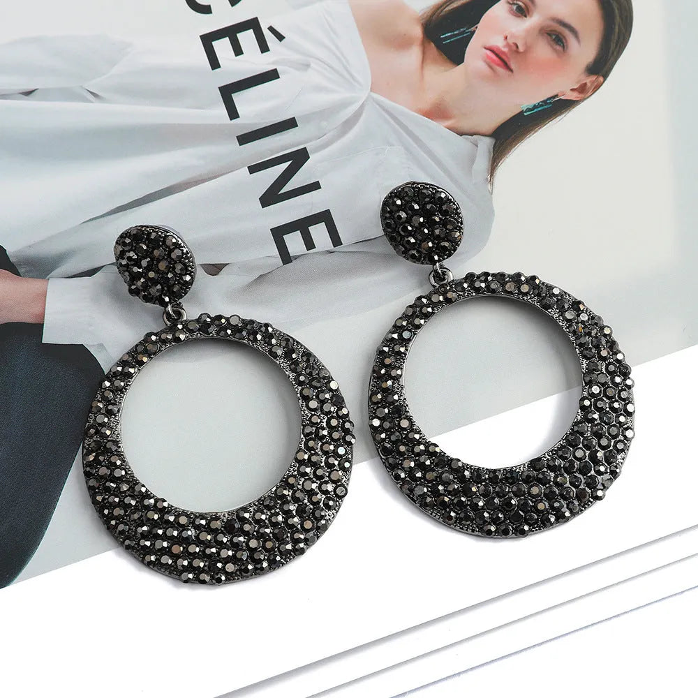 Large round pendant earrings with colourful diamond details on alloy metal, cartoon style