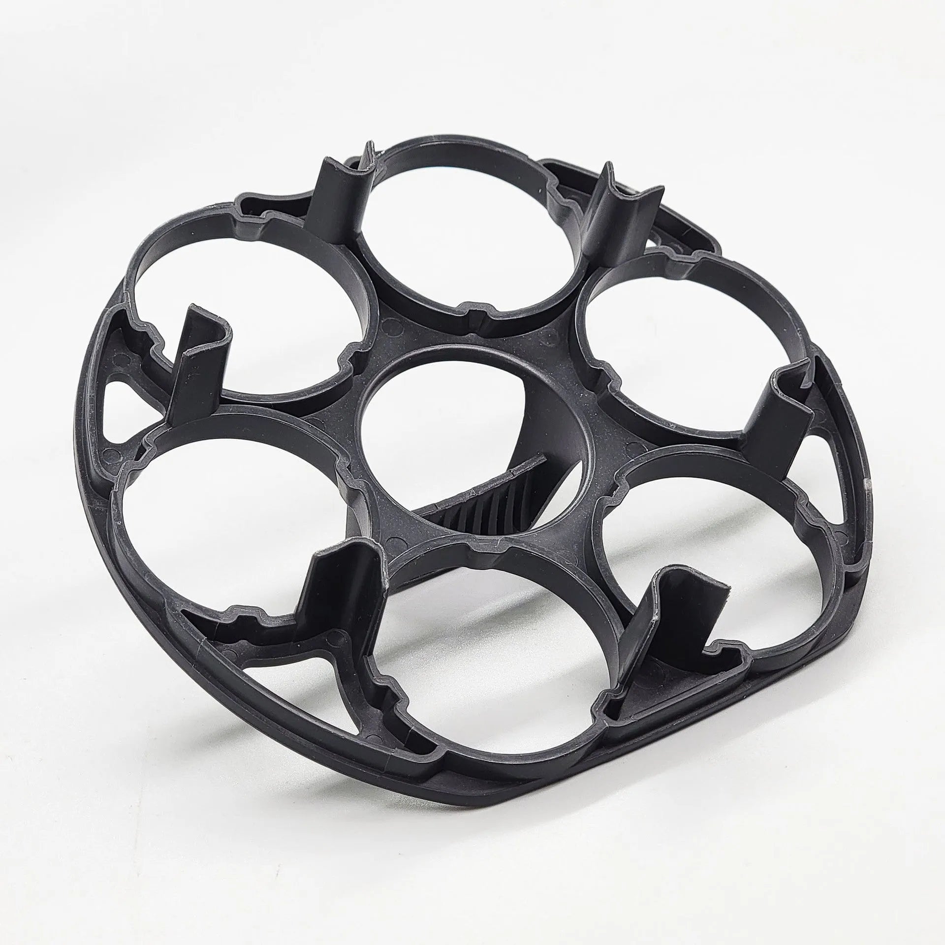 Black modern plastic egg holder rack on a kitchen surface.