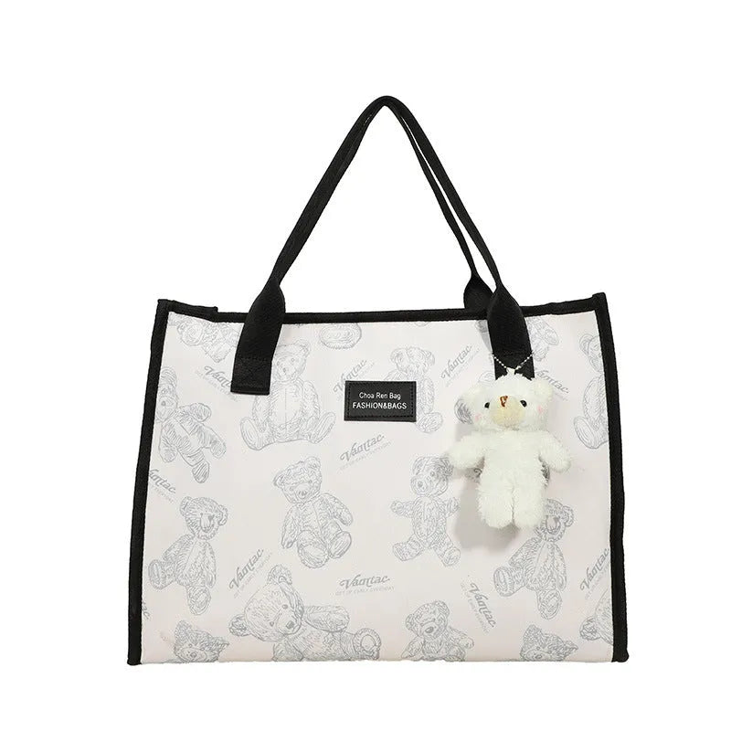 Women's black canvas tote bag with rhombus pattern, horizontal shape and shoulder strap