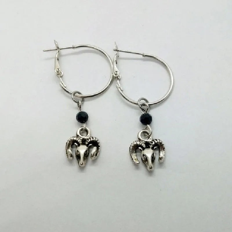 A pair of silver-coloured alloy round ring earrings for women on a white background.