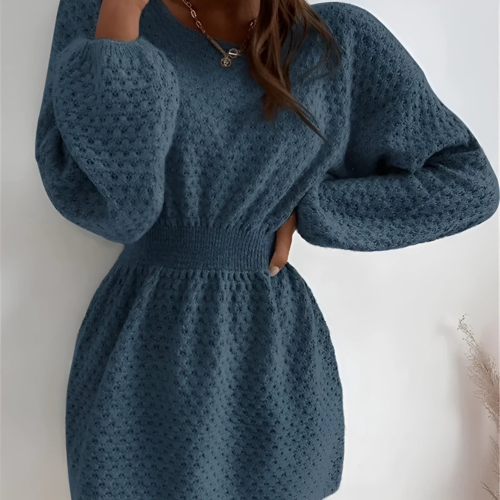 Blue knitted dress with French loose round neck, fitted waist, and hand-crocheted flower decorations