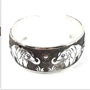Open design Miao ethnic bracelet in silver alloy with carved turtle or elephant motif.