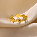 Gold diamond geometric titanium steel ring on a woman's hand.