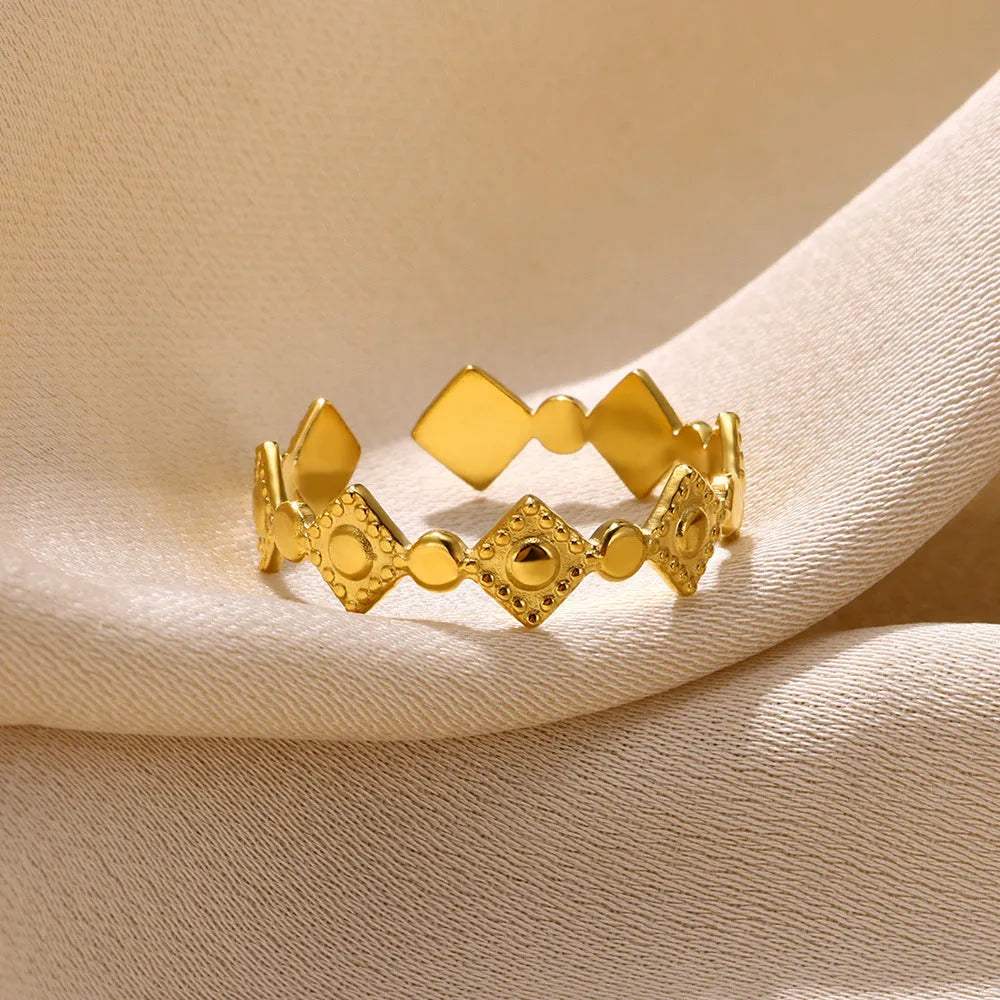 Gold diamond geometric titanium steel ring on a woman's hand.