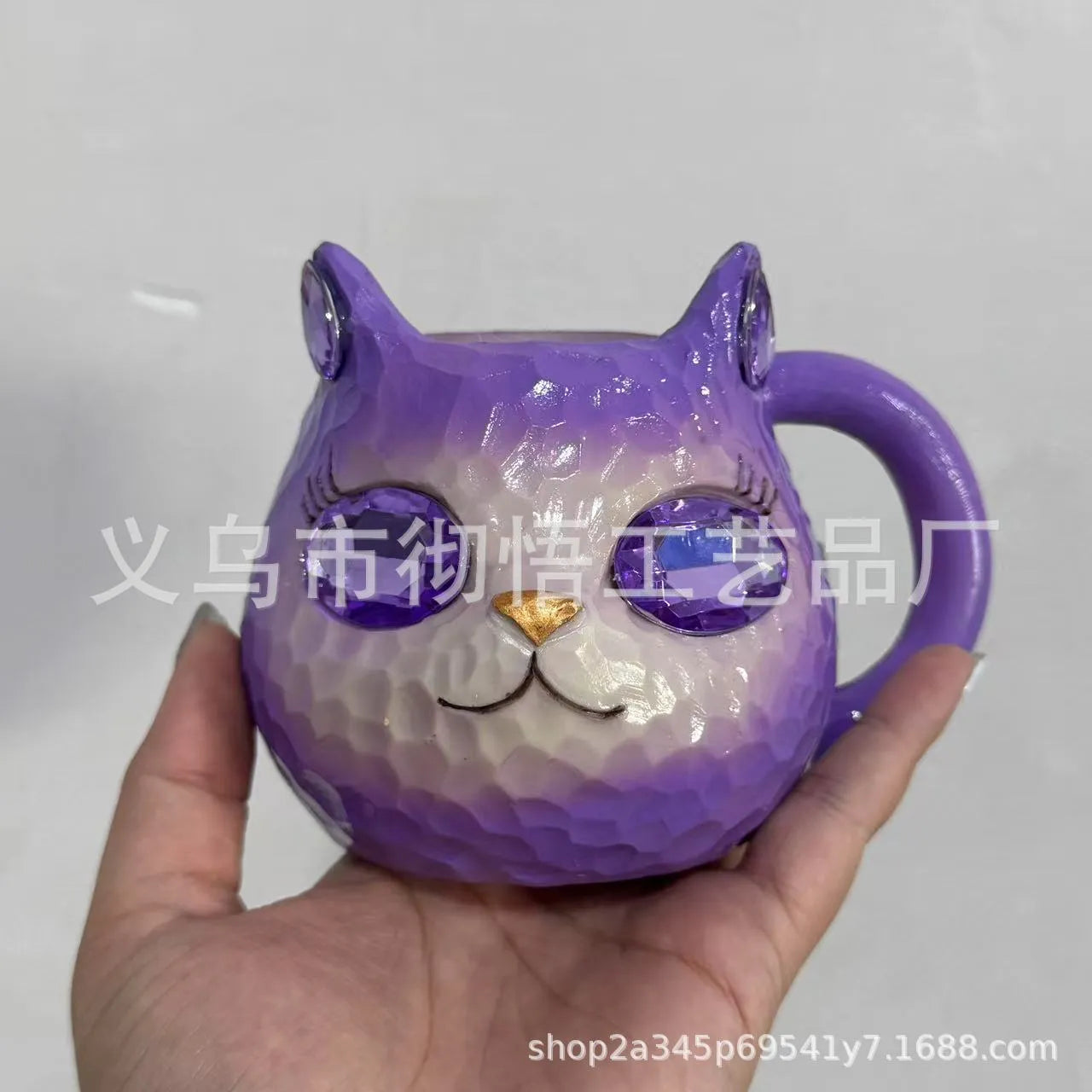 American-style resin ornament of a cat holding a crystal Earth globe in blue, green, pink, or purple.