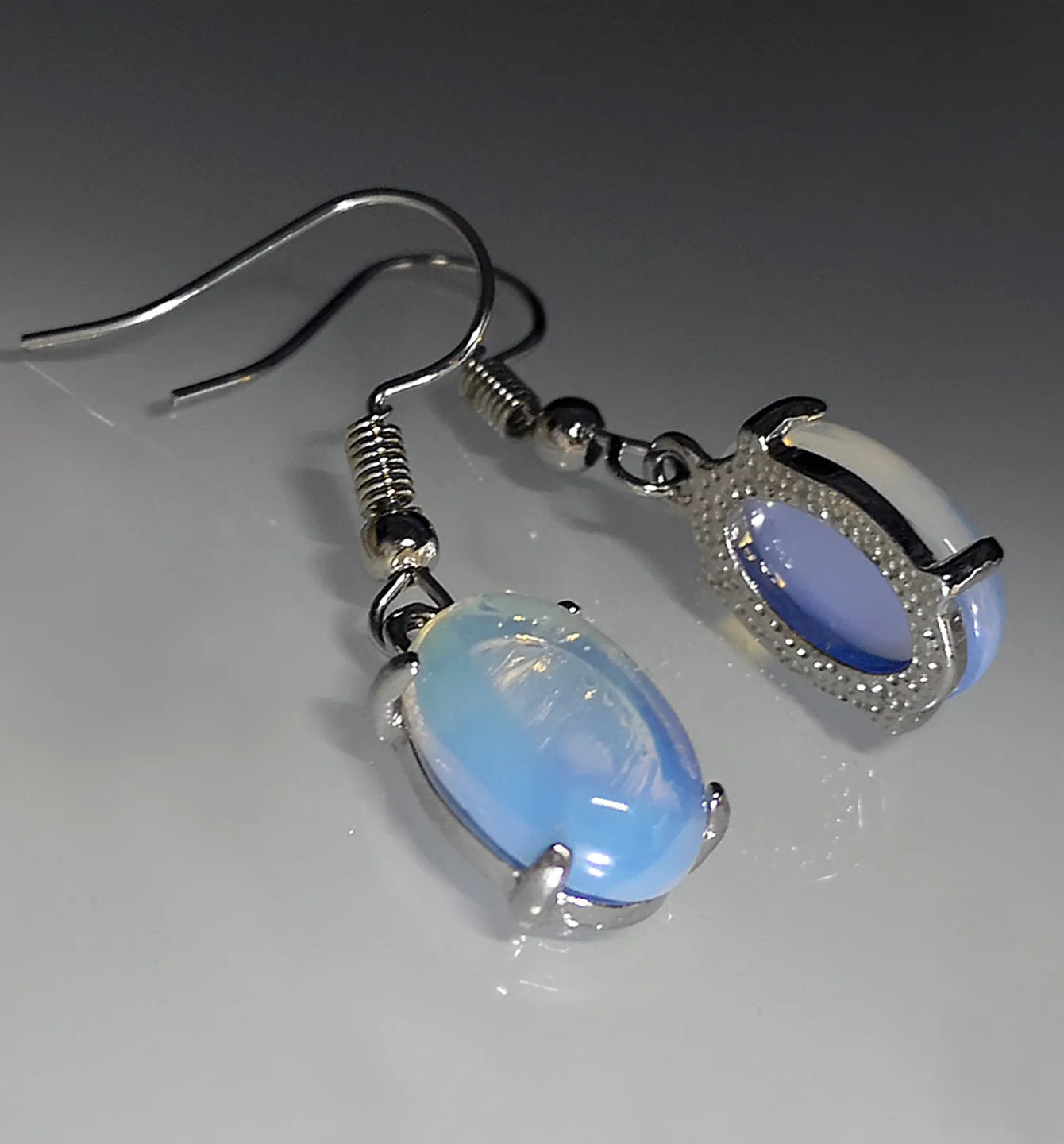 Moonlight white opal earrings with retro cross design and drop shape featuring ellipse elements