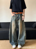 Men's retro blue distressed denim jeans with slim fit wide leg design showing machete wash detailing