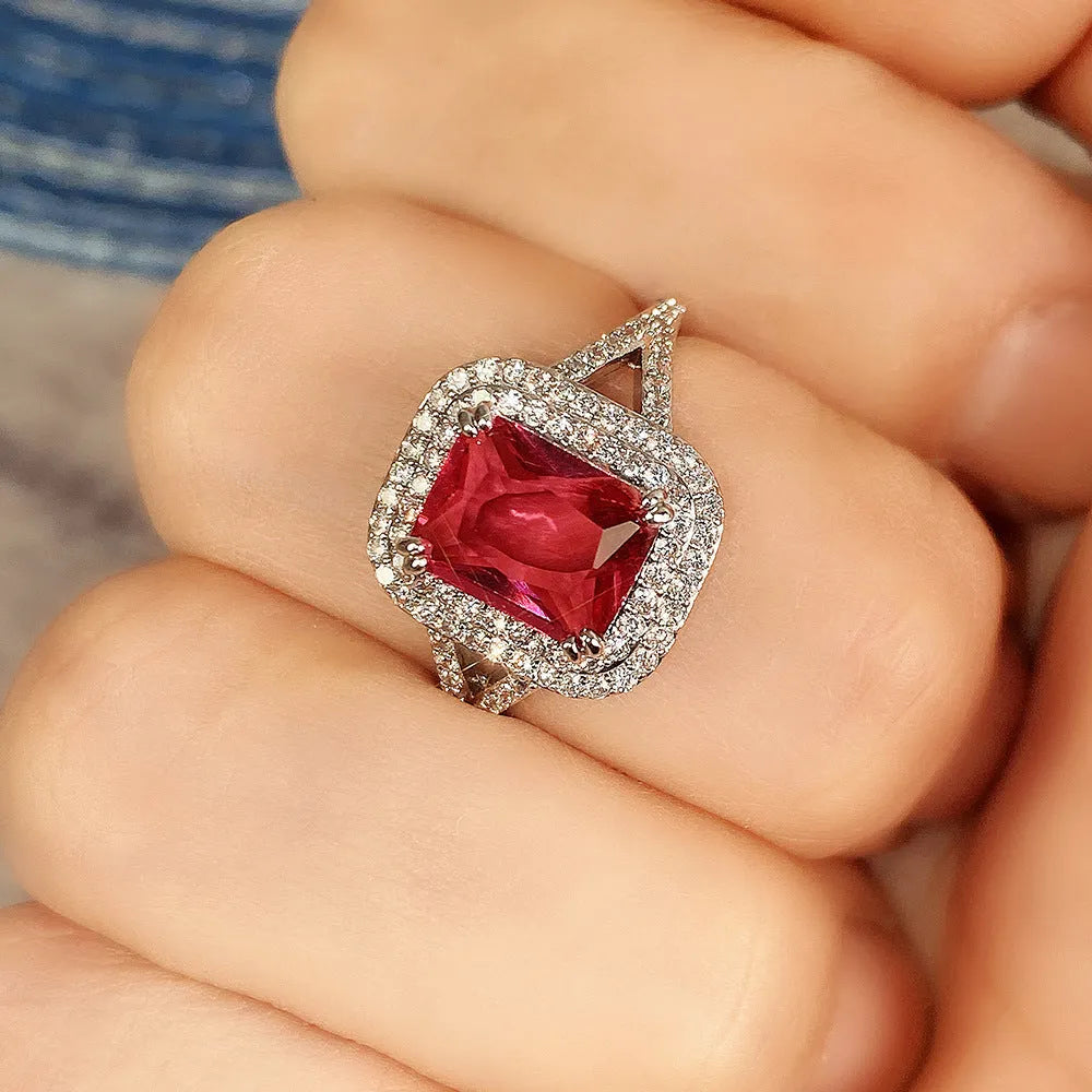 Copper square ring with a large red princess-cut rhinestone on a model's finger.
