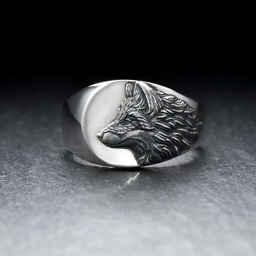 Silver geometric wolf head men's ring made from alloy metal on a grey background.