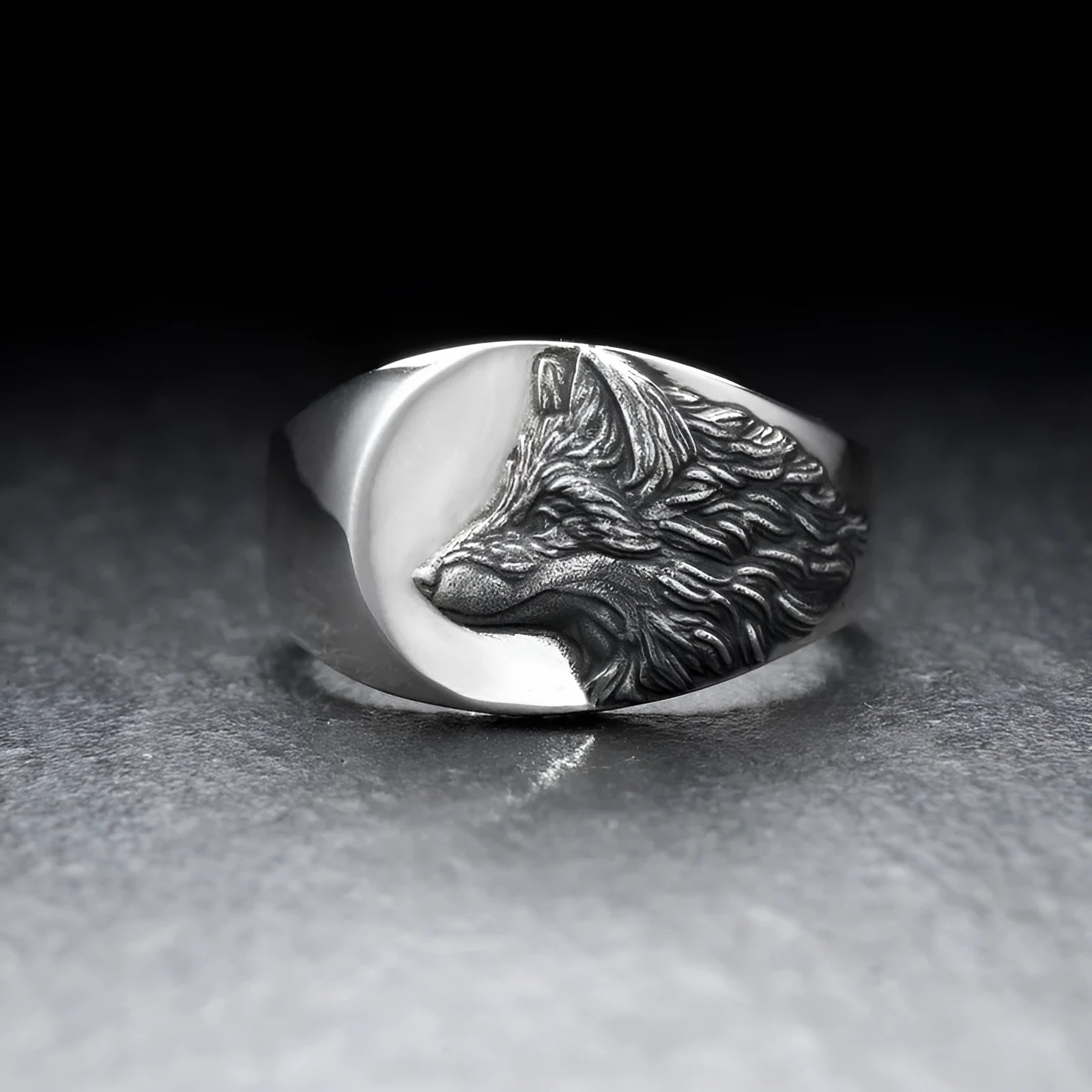 Silver geometric wolf head men's ring made from alloy metal on a grey background.
