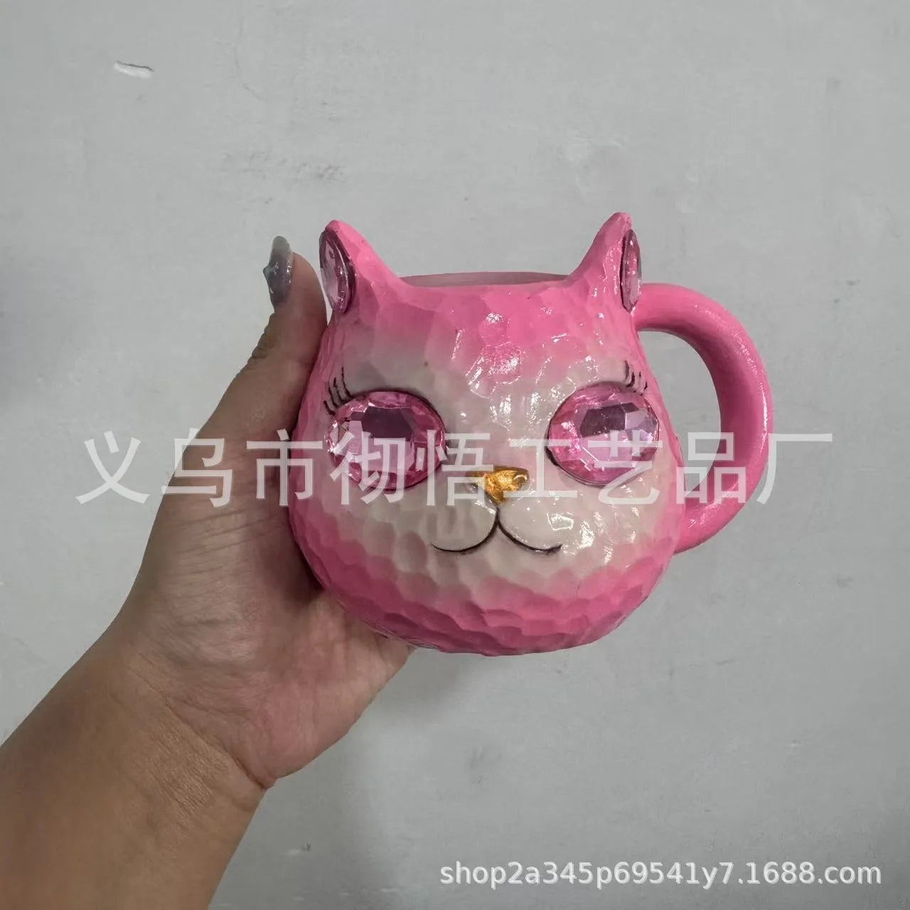 American-style resin ornament of a cat holding a crystal Earth globe in blue, green, pink, or purple.