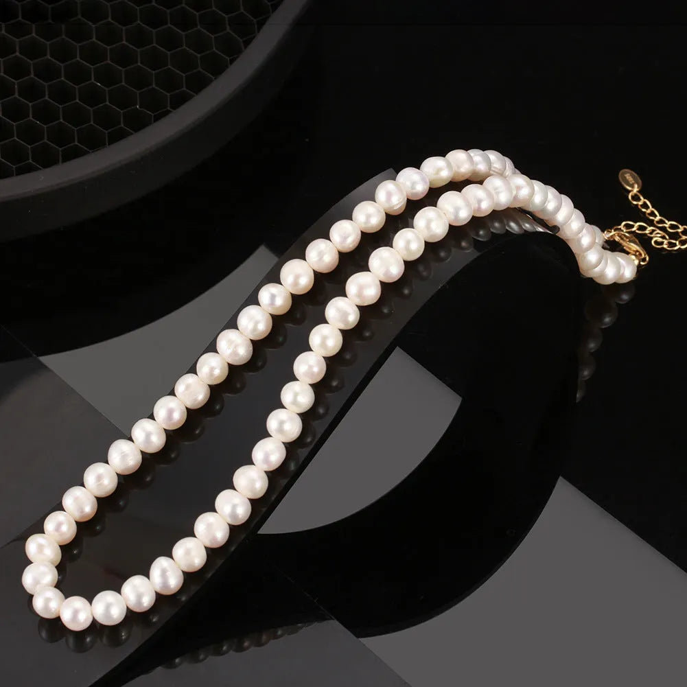 Women's adjustable sterling silver necklace with a single natural freshwater pearl pendant.