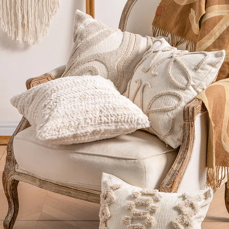 Knitted sofa pillow cover with tassel detailing in spiral dot pattern