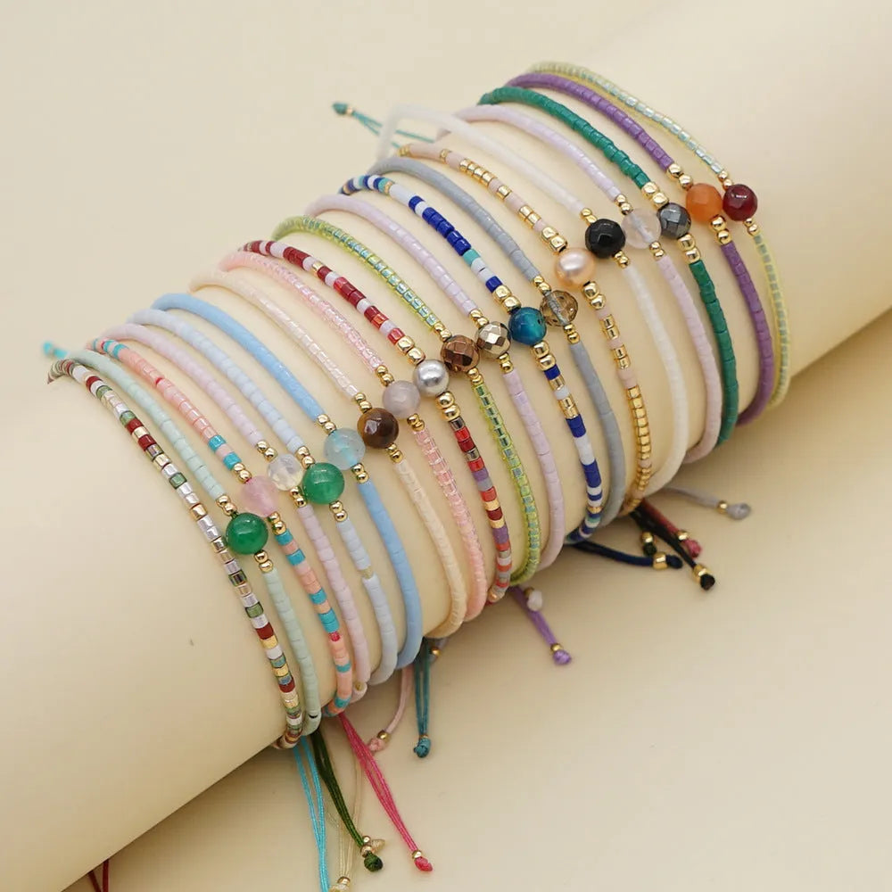 Women's handmade geometric beaded bracelet in bohemian style with glass and coloured glaze materials