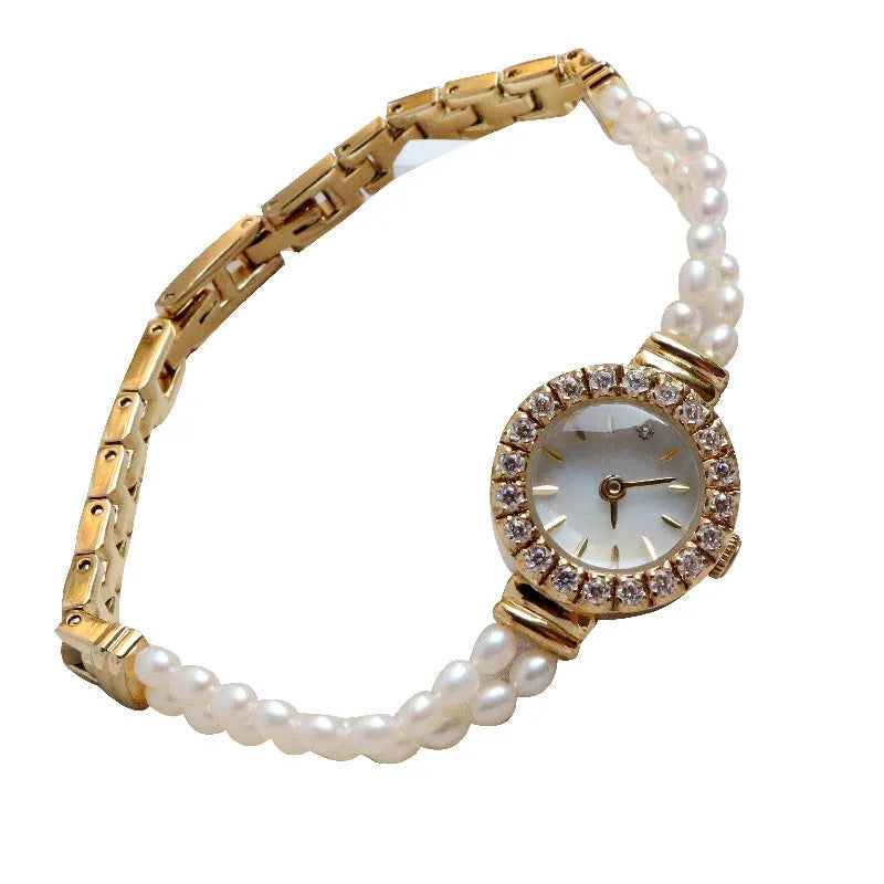 Light gold women's bracelet watch with freshwater pearls and a round dial