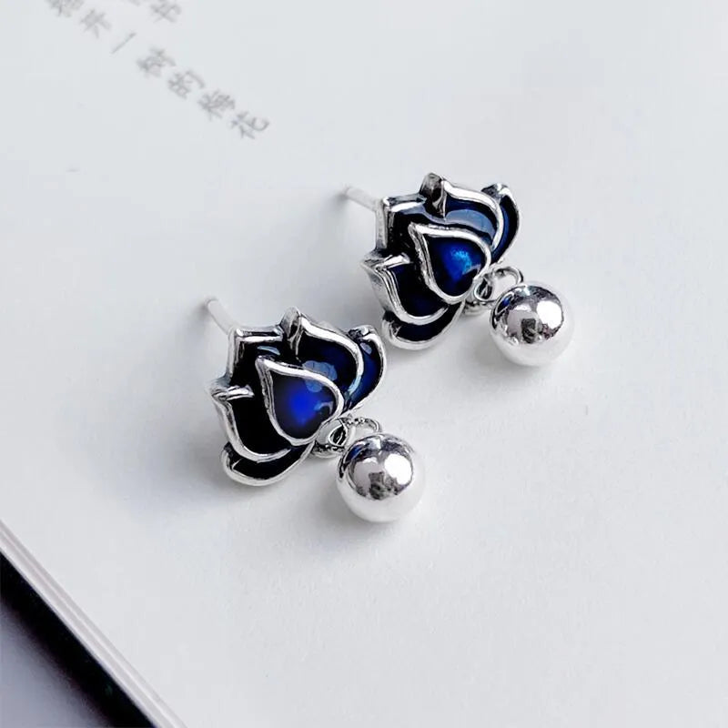 Blue lotus earrings with flower-shaped studs and artistic lotus seedpod tassel dangle
