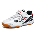 White and blue low-top badminton shoes with a ribbed sole and round toe on a hard court surface.