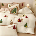 Bright yellow fleece-lined four-piece bedding set with cartoon Christmas tree pattern, shown on a bed.