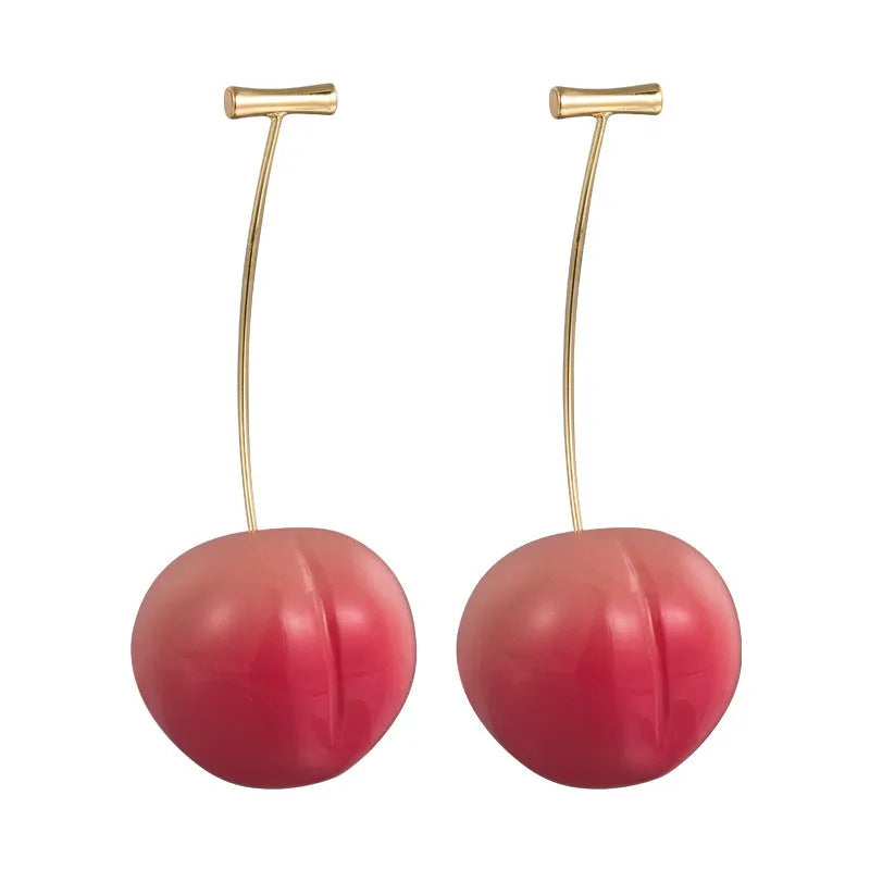 A pair of peach-shaped acrylic earrings in orange and green, shown in small and large size variants.
