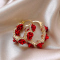 Red floral alloy ear clips with rose design and clip fastening