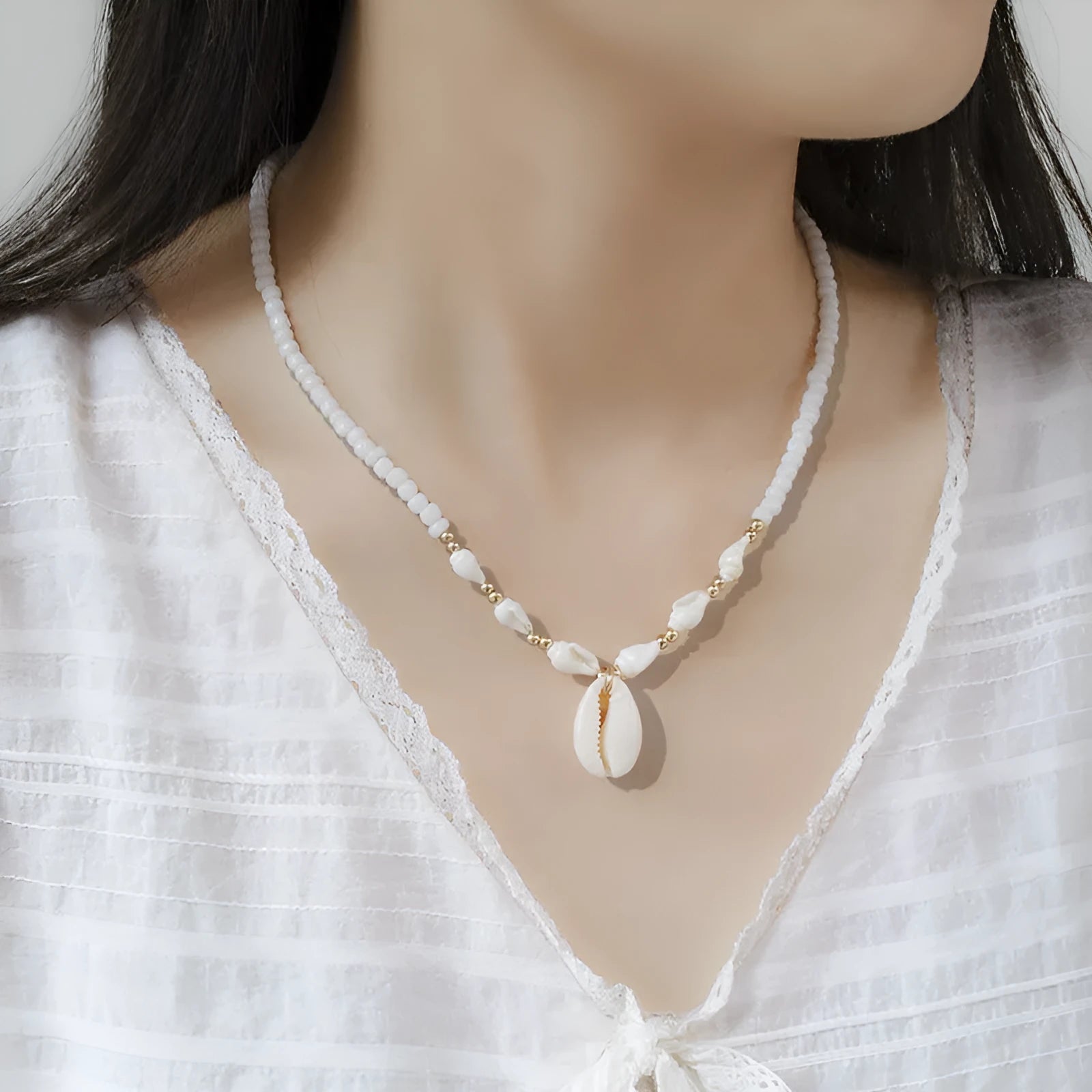 White conch shell necklace with a mother pearl pendant on a regular chain.