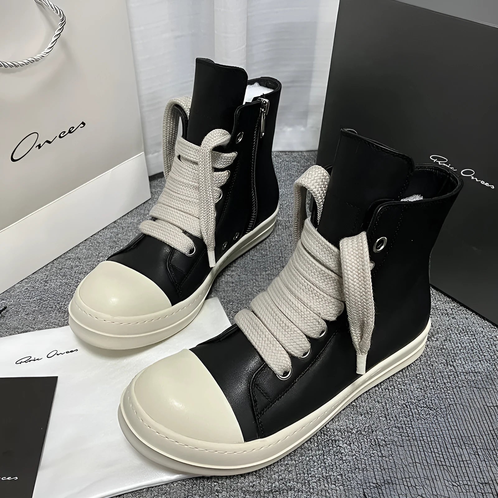 Black high-top leather casual sneakers with a side zipper and a round toe on a rubber sole.