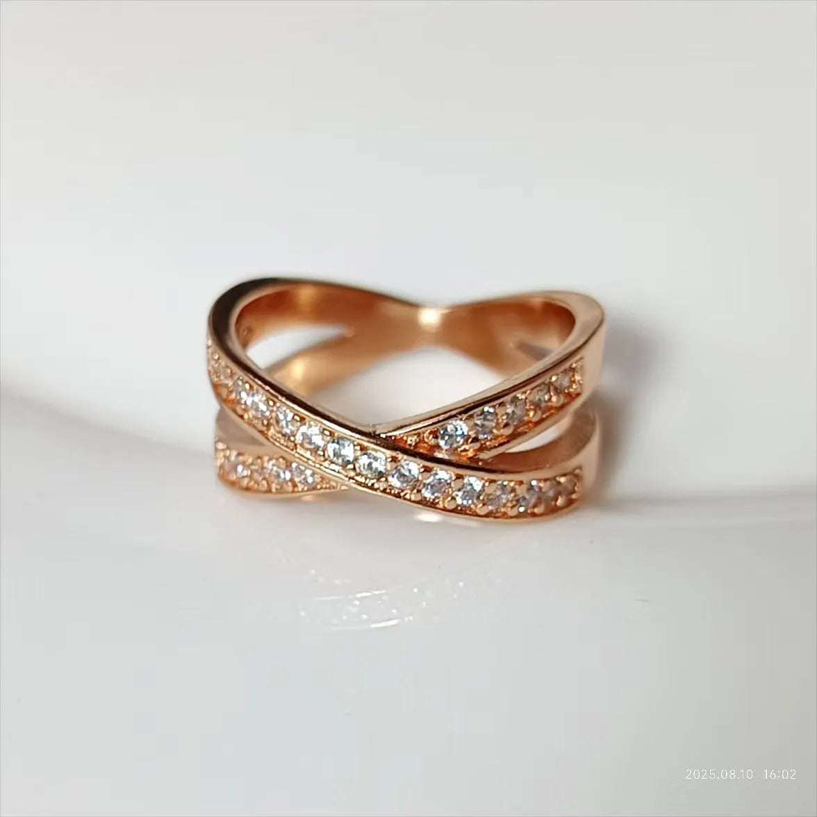 Geometric heart-shaped copper cross ring with micro-inlaid zircon in silver or rose gold finish.