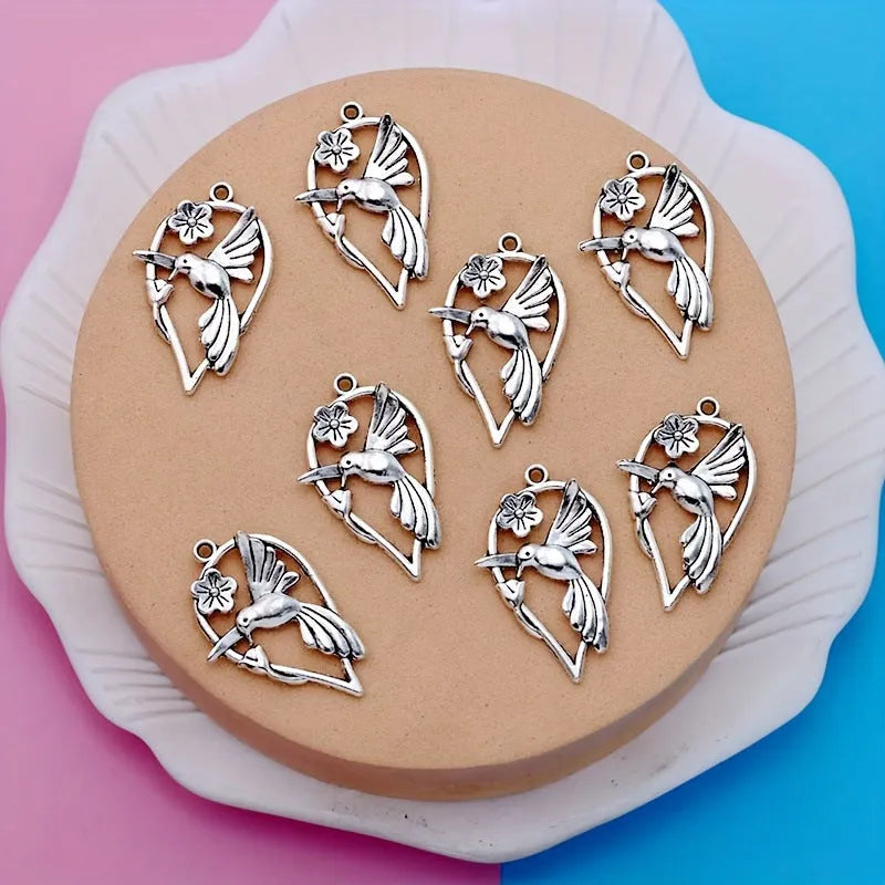 Close-up of a gold-toned alloy pendant with a detailed magpie bird design for DIY jewellery.