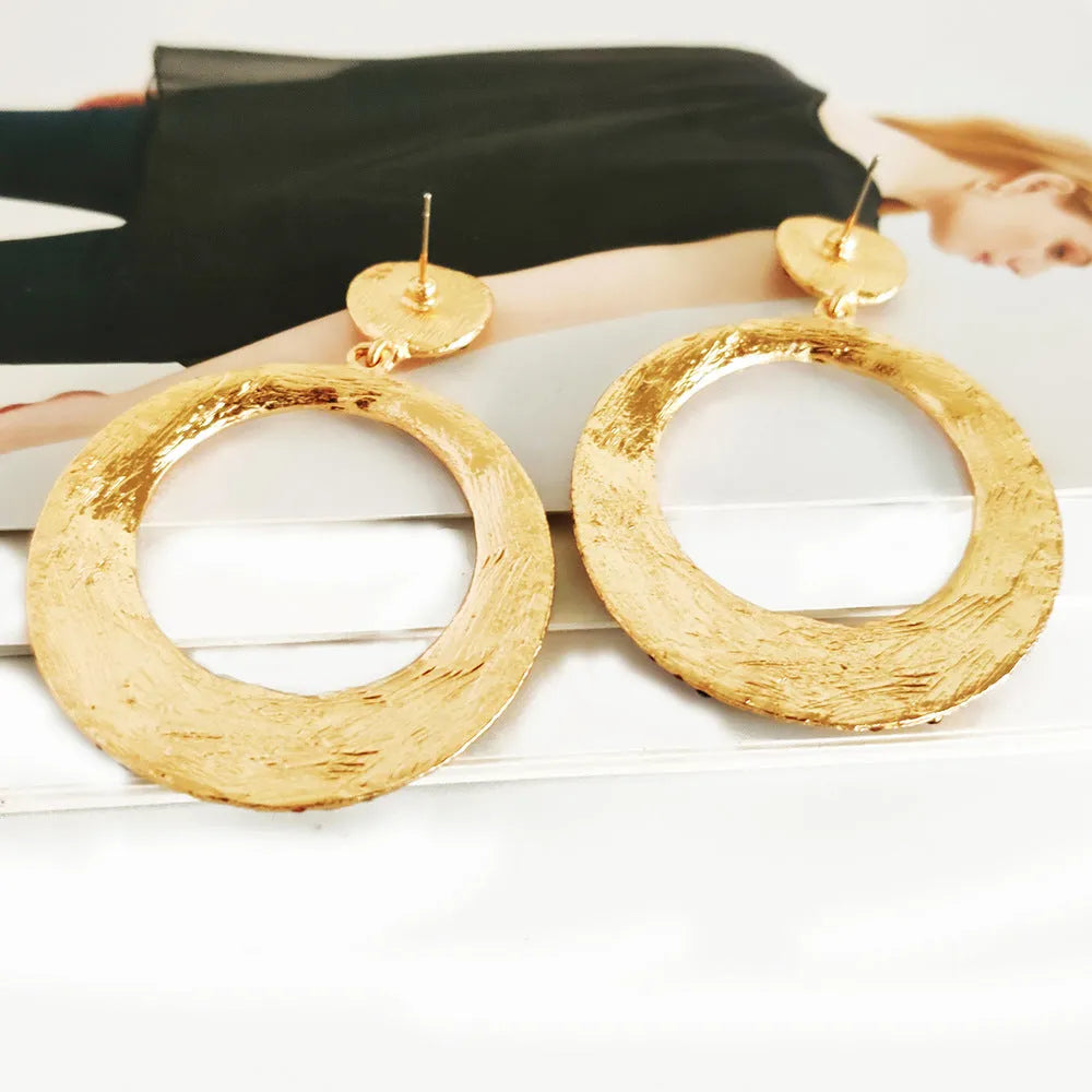 Large round pendant earrings with colourful diamond details on alloy metal, cartoon style