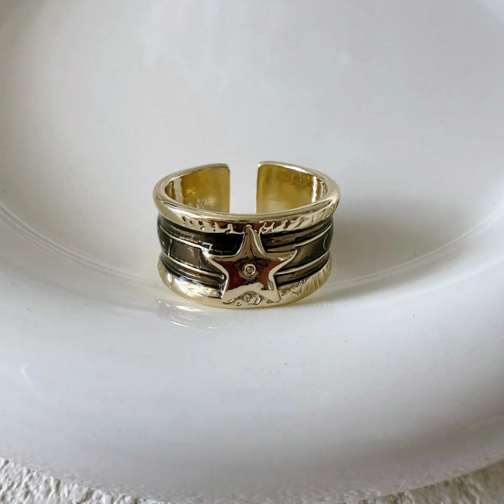 Adjustable geometric oil drop ring in distressed retro finish on copper, showing colour options.
