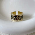 Adjustable geometric oil drop ring in distressed retro finish on copper, showing colour options.