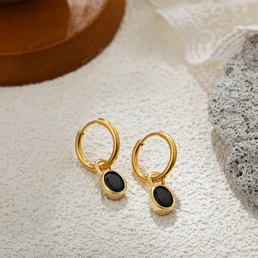 Close-up of women's retro oval zircon earrings in copper, showing the elliptical gemstone setting.