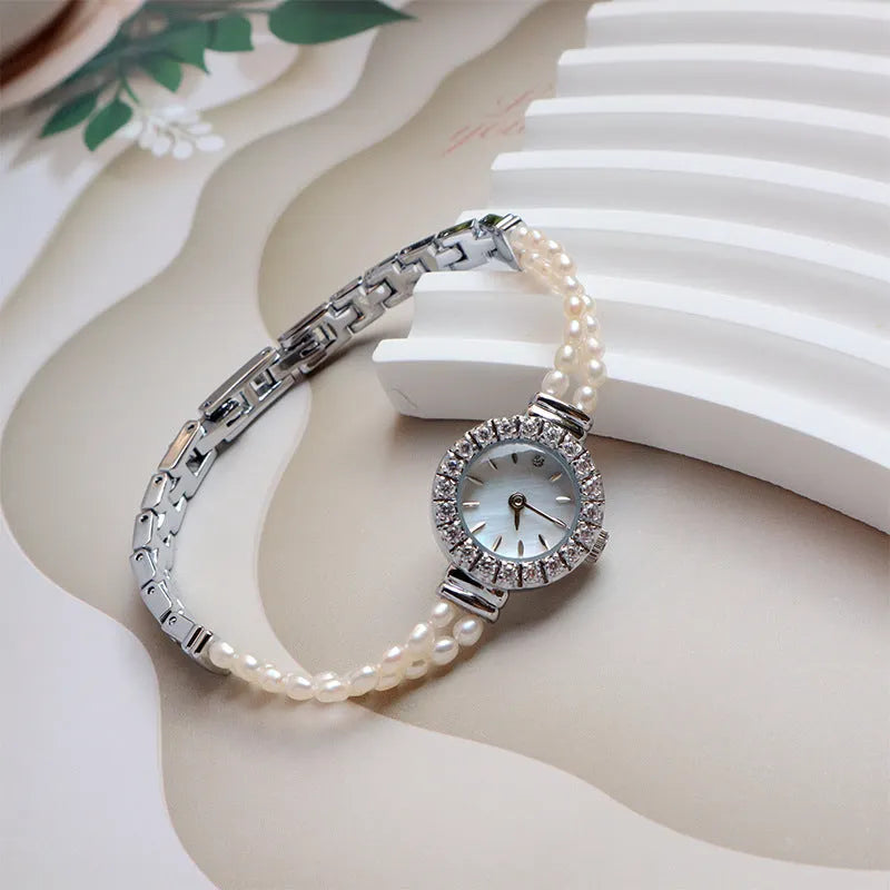 Light gold women's bracelet watch with freshwater pearls and a round dial