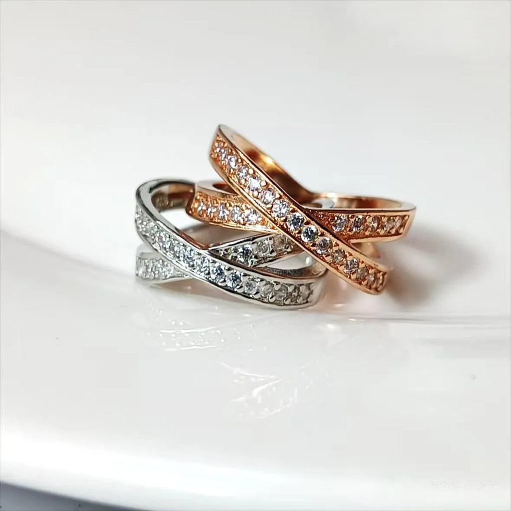 Geometric heart-shaped copper cross ring with micro-inlaid zircon in silver or rose gold finish.