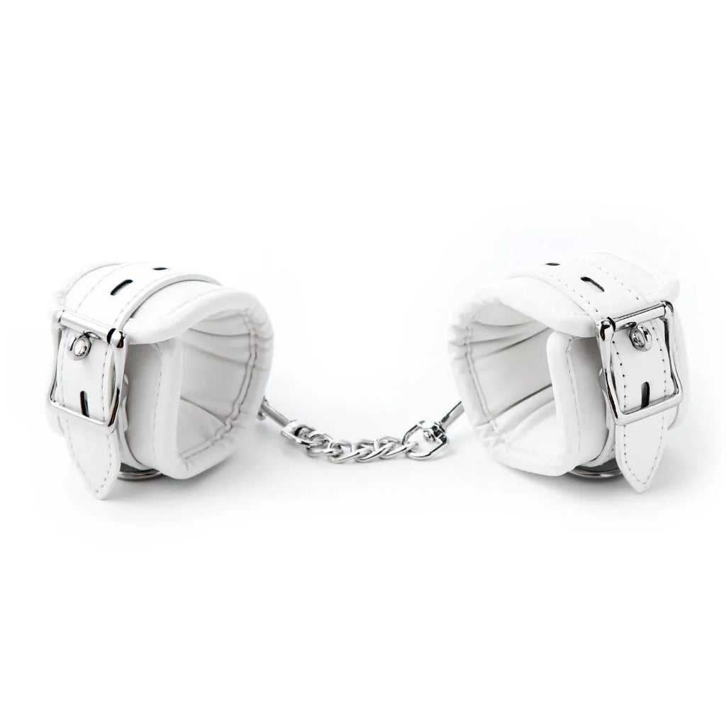 White PU sponge bondage set showing soft handcuffs, foot cuffs, and a neck cuff.