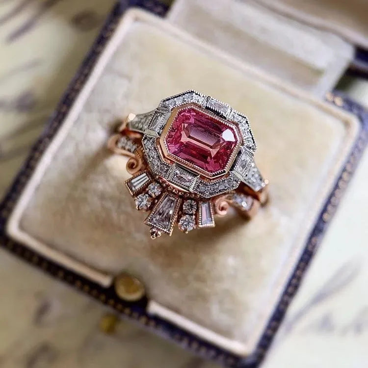 Rose gold geometric alloy women's ring with a retro ruby style on a grey background.