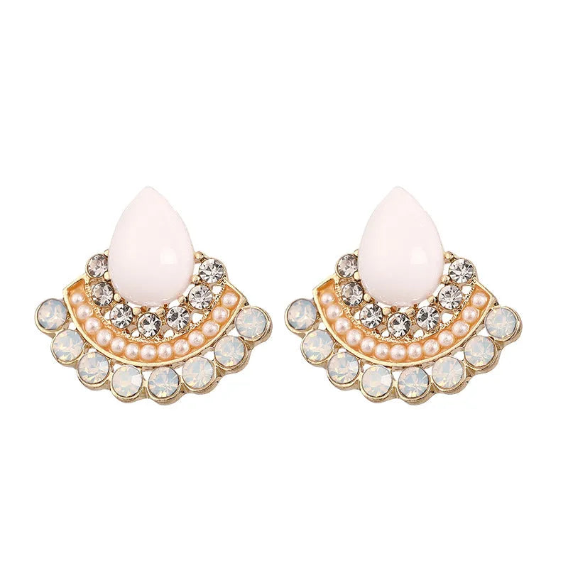 A pair of silver-toned retro fan-shaped drop earrings with a needle opal centre and sparkling rhinestone details.