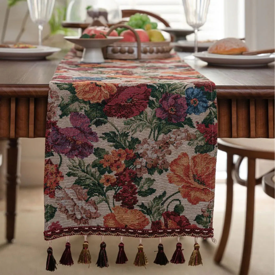 American-style beige jacquard table runner with floral pattern and long tassels on a dining table.