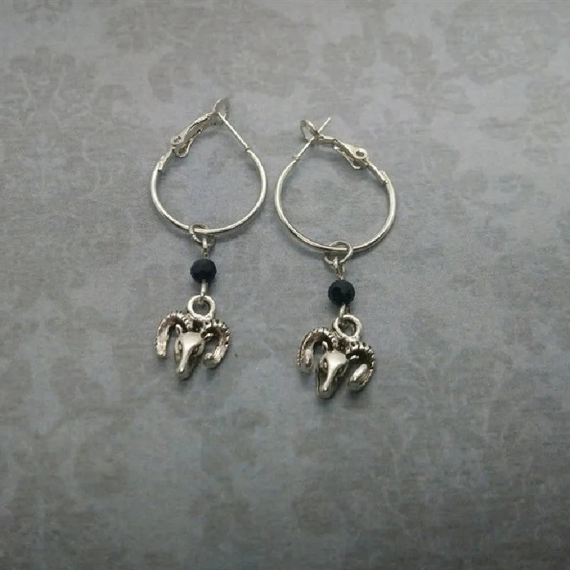 A pair of silver-coloured alloy round ring earrings for women on a white background.