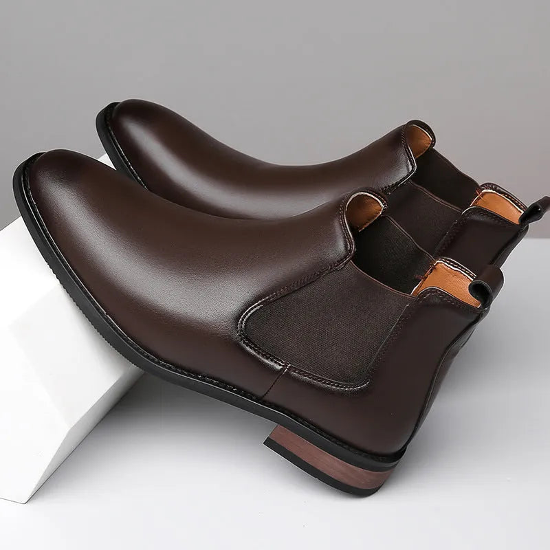 Men's black Chelsea boots with round pointed toe and visible stitching detail