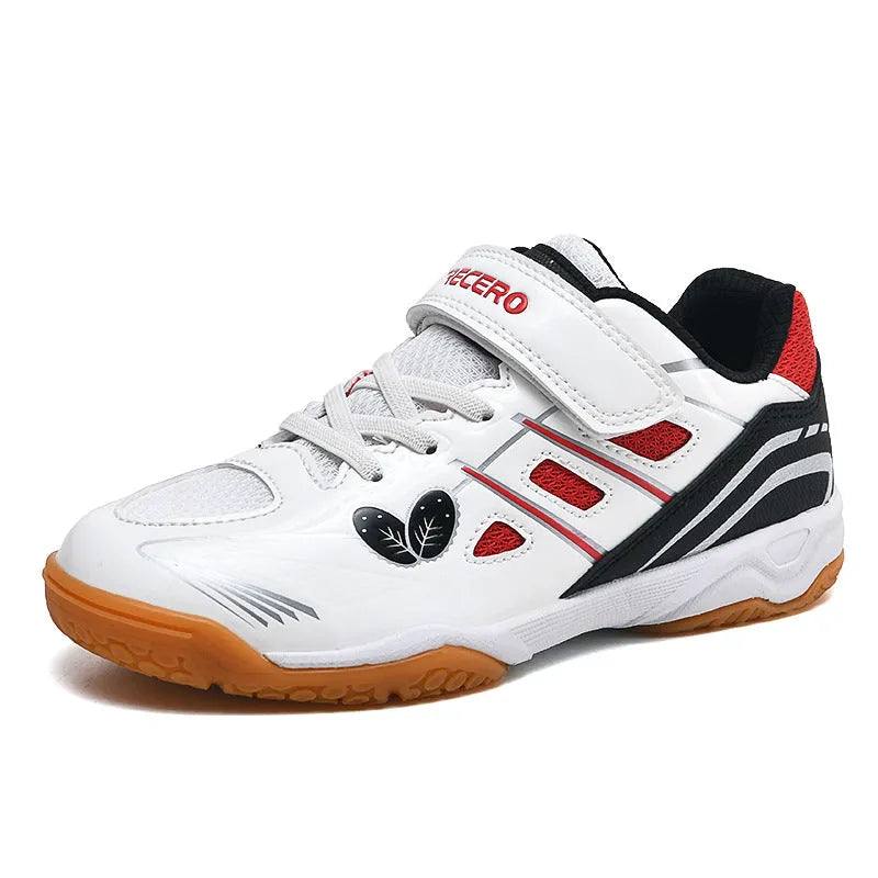 White and blue low-top badminton shoes with a ribbed sole and round toe on a hard court surface.