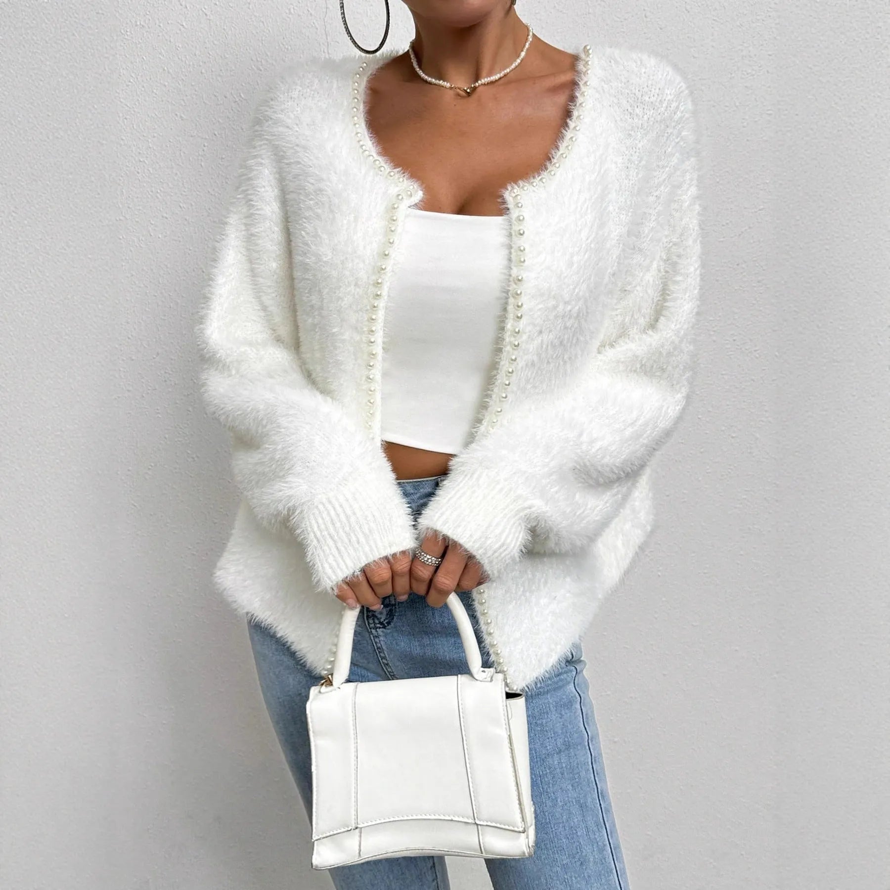 White women's V-neck cardigan sweater with polyester knit fabric and medium thickness