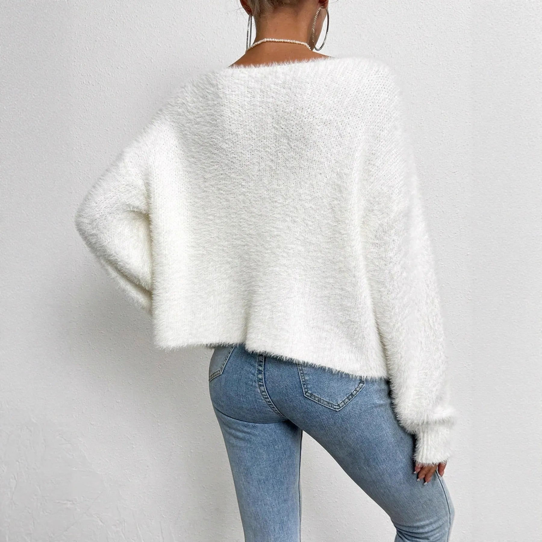 White women's V-neck cardigan sweater with polyester knit fabric and medium thickness