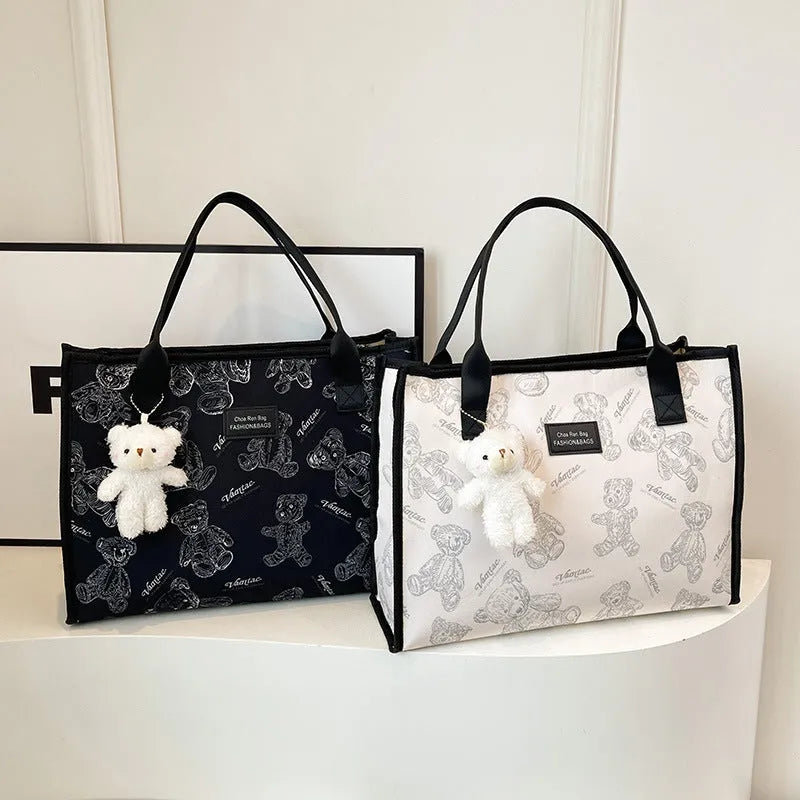 Women's black canvas tote bag with rhombus pattern, horizontal shape and shoulder strap